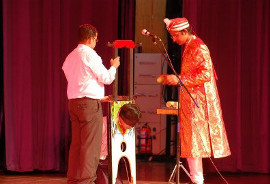 Magician Philip performing Head Chopper on Stage